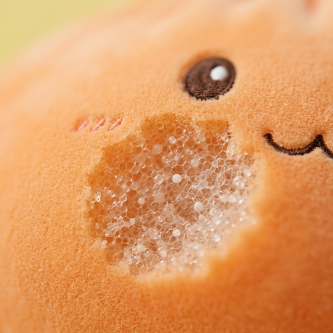 Giant Dumpling Squishy Naranja de Peluche — primer plano macro de la textura